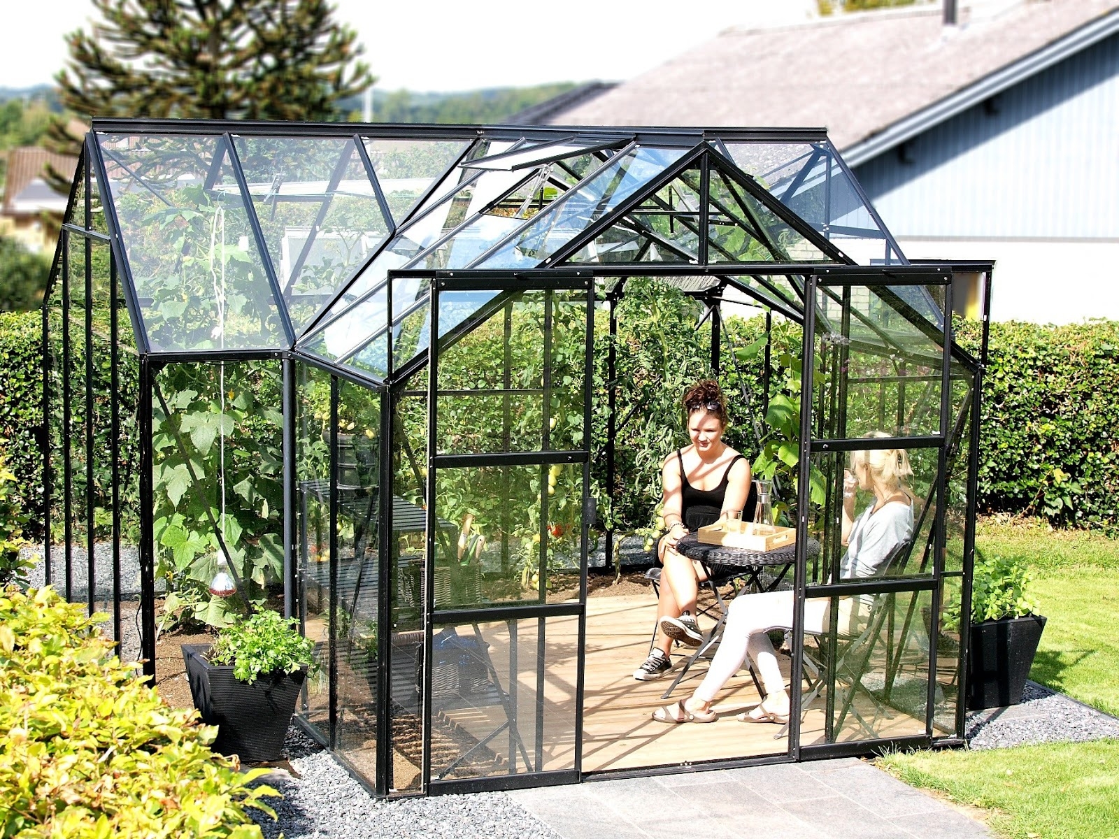 Alternative Uses for Your Greenhouse People sit in greenhouse